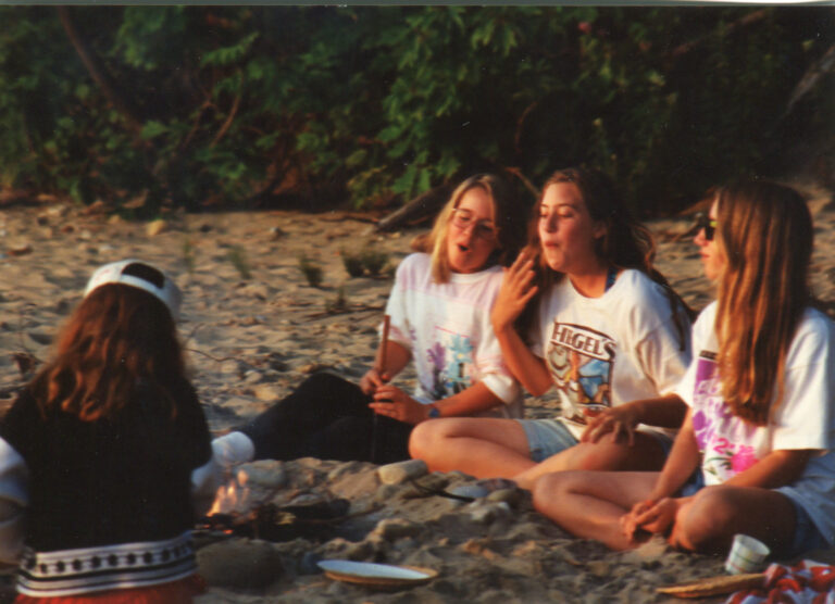 Kathleen Eder at 10 years old with friends around a camp fire.